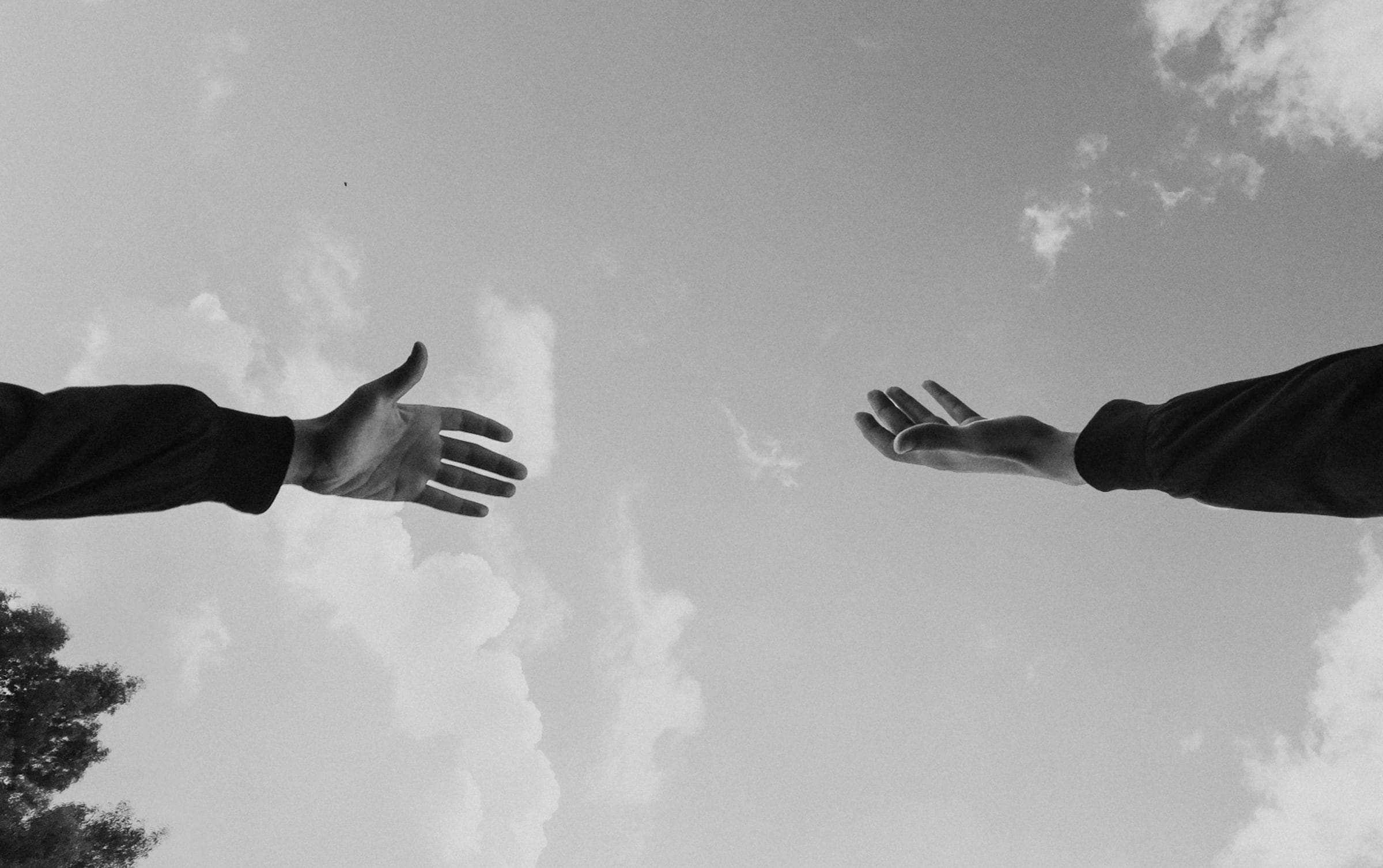 Hands reaching to sky